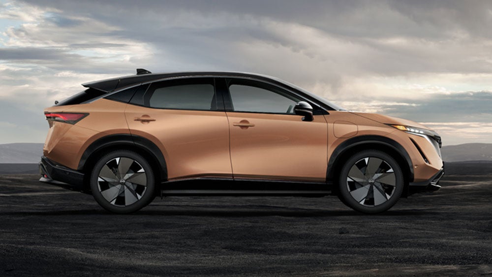Nissan ARIYA in Sunrise Copper in dramatic landscape | Nissan of Florence in Florence AL