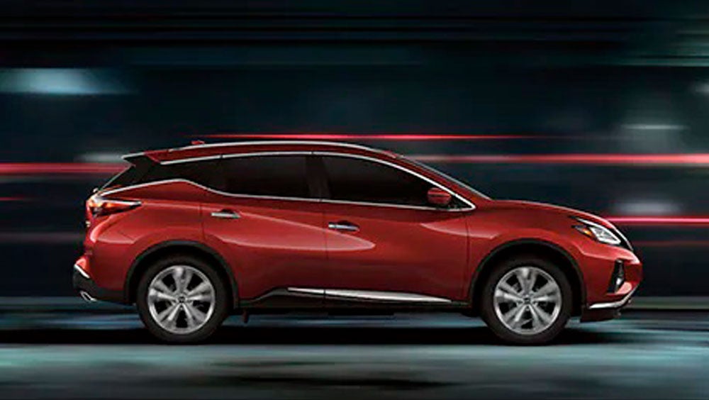 2023 Nissan Murano shown in profile driving down a street at night illustrating performance. | Greenway Nissan of Florence in Florence AL